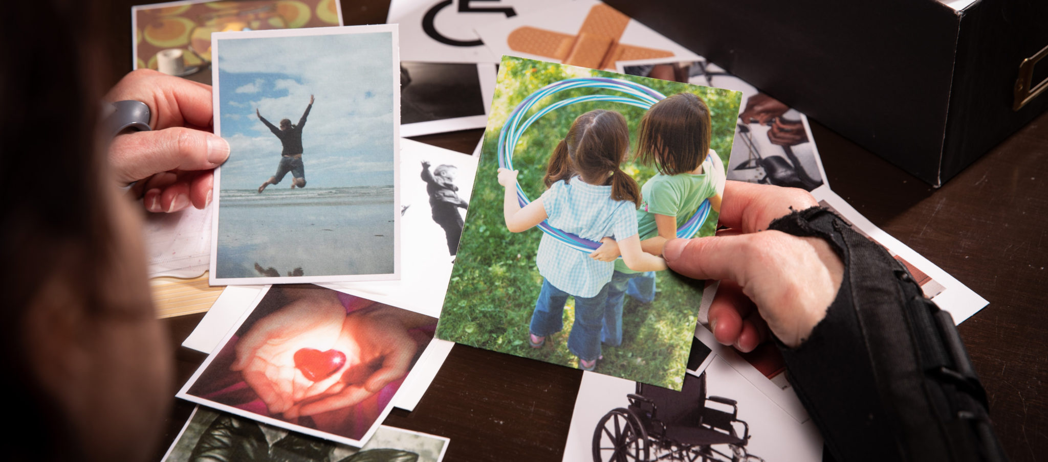 Image of hands collecting card box photos to show pain history