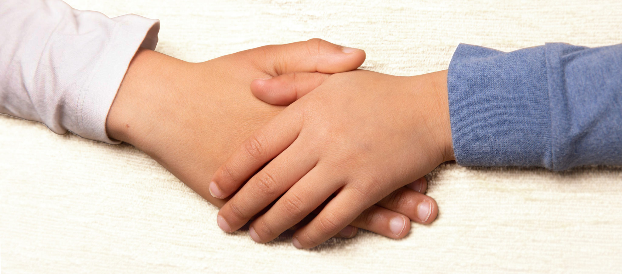 Image of siblings holding hands